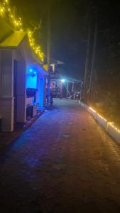 an empty street at night with lights on at Vintage villa in Varkala +4 photos