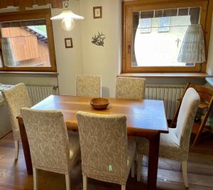 a dining room with a wooden table and chairs at Ciaseles a due passi da Cortina d'Ampezzo in San Vito di Cadore