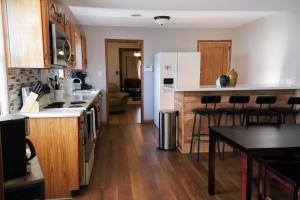 a kitchen with wooden floors and white appliances at Escape at The 75 in Bristol