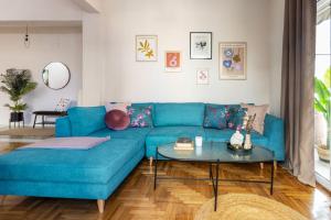 a blue couch in a living room with a table at Home of Petros in Athens +22 photos