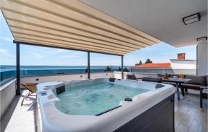 a large bath tub sitting on top of a balcony at Villa Futura in Zadar