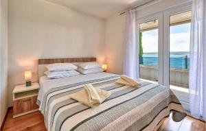 a bedroom with a bed with a view of the ocean at Villa Futura in Zadar