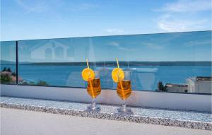 two glasses of orange juice sitting on a ledge at Villa Futura in Zadar +51 photos
