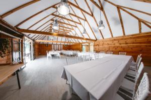 a large room with tables and chairs in a building at Ostoja Poleska in Kołacze