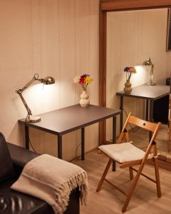 a room with a desk and a chair and a lamp at Central Luxury Cozy Modern Apartment in Sofia