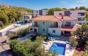 an aerial view of a house with a swimming pool at 3 Bedroom Lovely Home In Kostrena in Kostrena