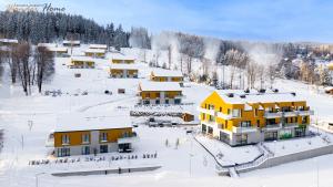 an aerial view of a resort in the snow at Wonder Home - Domki Hillside tuż przy stoku narciarskim - na terenie kompleksu plac zabaw i zewnętrzna siłownia, sklep, parking in Karpacz +229 photos
