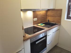 a kitchen with a stove and a sink at Deichblick Süderloog 38 in Spiekeroog +24 photos