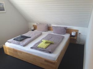 a bedroom with two beds with towels on them at Deichblick Süderloog 38 in Spiekeroog