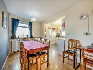 a kitchen and dining room with a table and chairs at Heritage Wharf in Mow Cop