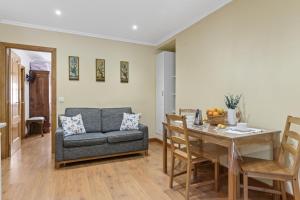 a living room with a couch and a table at Casa de Aldea La Pescal in La Pescal