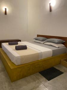 a bedroom with a bed with two pillows on it at Secret House in Dickwella