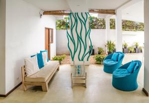 a living room with two chairs and a couch at Binnacle Negombo in Negombo