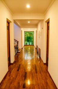 an empty hallway of a house with wooden floors at Binnacle Negombo in Negombo