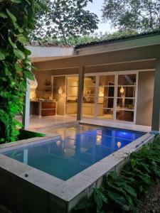 a swimming pool in front of a house at Casa Marco Zero - Pipa in Pipa