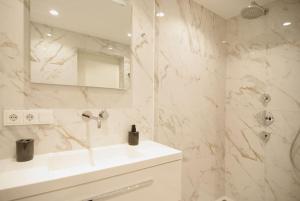 a white bathroom with a sink and a mirror at Spacious Suite at Park and Museum in Amsterdam +50 photos