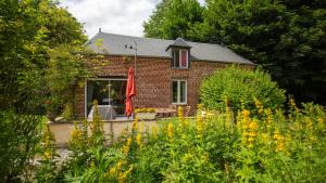 a brick house with a garden in front of it at Le Petit Chateau in Saint-Michel