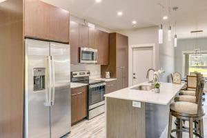 a kitchen with a stainless steel refrigerator and a sink at 4 Mi to Golf Quiet Lake Wales Retreat in Indian Lake Estates