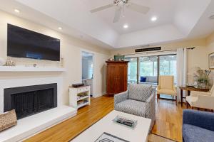 a living room with a fireplace and a tv at Inlet Cove 11 in Kiawah Island