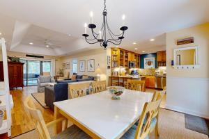 a dining room and living room with a table and chairs at Inlet Cove 11 in Kiawah Island +30 photos
