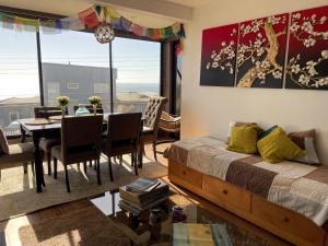 a bedroom with a bed and a dining room with a table at Departamento con Vista al Mar en Pichilemu in Pichilemu