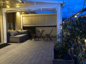 an outdoor patio with a couch and a table at Monolocale con ampio terrazzo in Milan
