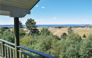 a view from the porch of a house with a blue bench at Three-Bedroom Holiday Home In Knebel in Knebel +27 photos