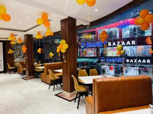 a restaurant with tables and chairs and orange balloons at Hotel Gajraj Near M G Marg in Gangtok
