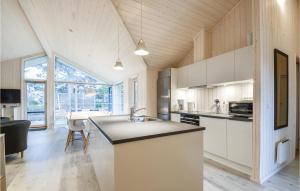 a kitchen with white cabinets and a large window at Six-Bedroom Holiday Home In Ebeltoft in Ebeltoft
