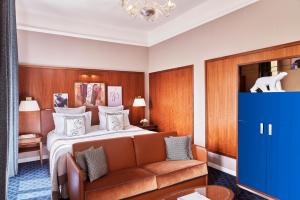 a hotel room with a bed and a couch at Hôtel Barrière Le Westminster in Le Touquet-Paris-Plage