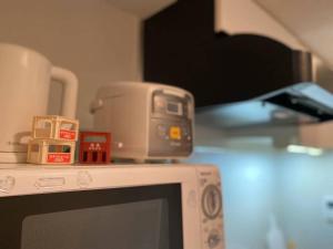 a counter top with a appliance on top of a microwave at Shinjuku house 2 in Tokyo