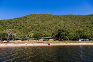 a view of a beach with a mountain in the background at Plettenberg, a Forever Resort in Plettenberg Bay