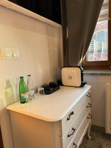 a kitchen counter with glasses and bottles on it at AmaMolto Train Station in Opole