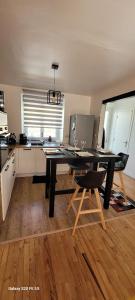 a kitchen with a black table and chairs in a room at maison cosy in Quimper +8 photos