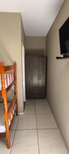 a living room with a tiled floor and a television at Hotel Modelo Rio Pardo in Ribas do Rio Pardo
