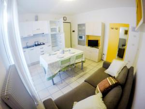 a living room with a couch and a kitchen at Residence Solemar - Agenzia Cocal in Caorle