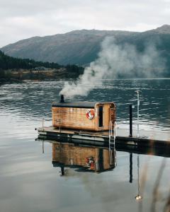 a dock on a body of water with smoke at Yttervik in Mo i Rana +56 photos