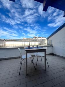 a table and two chairs on a balcony with a view at Affori MM centro in Milan