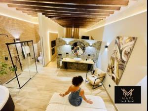 a little girl sitting on a pillow in a room at Winahost Algar Rural in Algar