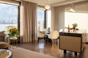 a dining room with a table and a large window at Maison Hudson in New York
