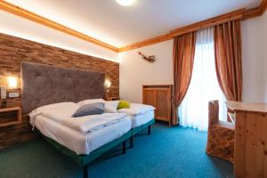 Postel nebo postele na pokoji v ubytování Hotel Ciamol