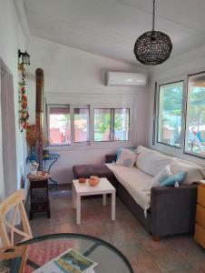 a living room with a couch and a table at Amaryllis sweet home in Pyrgos