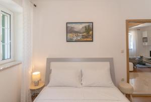 Postel nebo postele na pokoji v ubytování Apartments Srdanovic