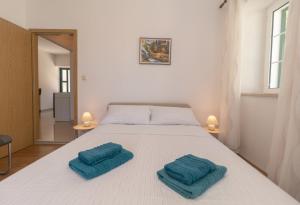 Postel nebo postele na pokoji v ubytování Apartments Srdanovic