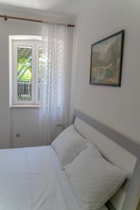 Postel nebo postele na pokoji v ubytování Apartments Srdanovic