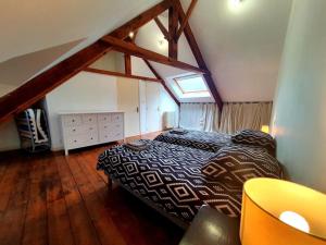 a bedroom with a large bed in a attic at La Capitainerie Port du Légué in Plérin