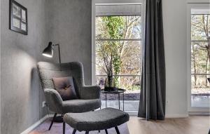 a living room with a chair and a lamp at Stunning Home In Ebeltoft With Wifi in Ebeltoft