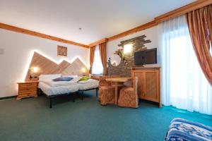 Postel nebo postele na pokoji v ubytování Hotel Ciamol