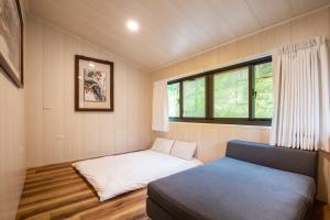 a small bedroom with a bed and a window at Song Hua Ju B&B in Heping