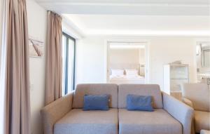 a living room with a couch with two blue pillows at Prince in Binz